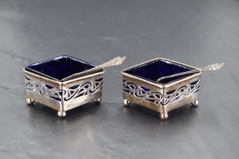 A pair of Edwardian silver salts of diamond form having pierced decoration, blue golass liners and - Image 2 of 2