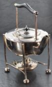A silver plated spirit kettle on stand, having a yoke-form handle with elongated tubular supports,