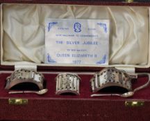A cased silver three piece crust set having pierced decoration and blue glass liners, Sheffield
