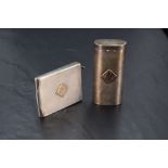 A silver match card holder having engine turned chequered decoration and bearing appliquéd