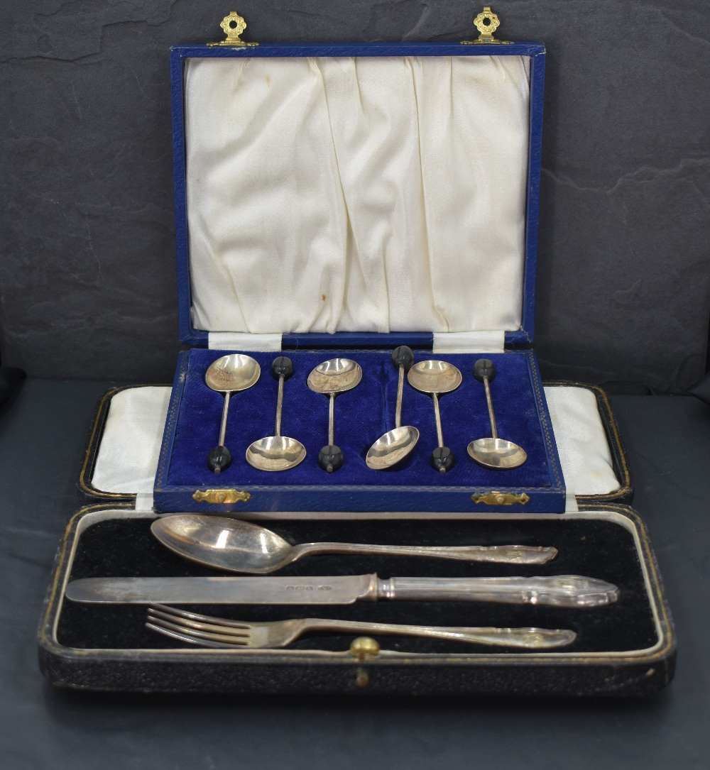 A George V cased silver three-piece christening set, comprising knife, fork and spoon, each