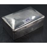 An Edwardian silver cigarette box, of hinged rectangular form with engine-turned decoration and