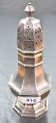 A George V silver sugar caster, of fluted octagonal form, with pierced finial topped cover,