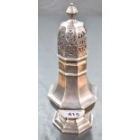 A George V silver sugar caster, of fluted octagonal form, with pierced finial topped cover,