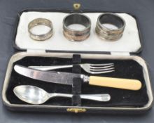 A child's cased HM silver spoon and fork bearing dated presentation inscription with additional