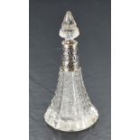 An Edwardian cut glass perfume bottle of conical form having cut glass stopper and moulded silver