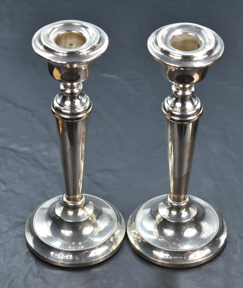 A pair of silver candle sticks of plain tapered form to weighted circular bases, Birmingham 1964, - Image 2 of 3