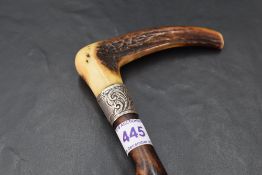 A Victorian white metal mounted and horn handled hawthorn walking cane, the scroll embossed white