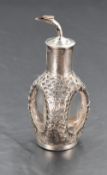 An Oriental silver overlaid glass bitters bottle having pourer with cork stopper and dragon