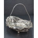 An Edwardian silver table basket of shallow lozenge form having pierced decoration, bun feet and