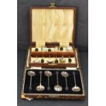 Two cased sets of silver coffee bean spoons, of traditional form, gross weight 70grams.
