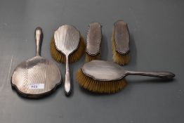 A 1920's silver-mounted five-piece dressing/brush set, comprising hand mirror, two hair brushes