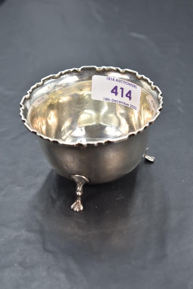 A George V silver sugar bowl, of circular form with moulded edge detail and three down-swept legs