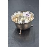 A George V silver sugar bowl, of circular form with moulded edge detail and three down-swept legs