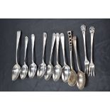 A group of mixed silver flatware, comprising spoons and two pickle forks, various dates, styles
