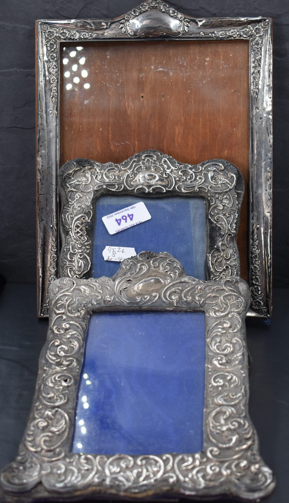 A group of three silver mounted photograph frames, two extensively moulded with C-scrolls, the other