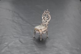 A small Victorian silver salon chair having embossed cherubic decoration, London 1897, Edward
