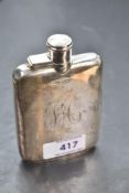 A silver hip flask of plain rectangular form bearing monogram to side and having bayonet lid,
