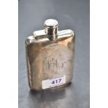 A silver hip flask of plain rectangular form bearing monogram to side and having bayonet lid,