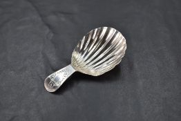 A George III silver caddy spoon, of fluted scallop form with short bright-cut handle, marks for