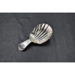 A George III silver caddy spoon, of fluted scallop form with short bright-cut handle, marks for