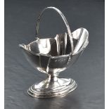 An early 20th Century swing handled sugar bowl having plain fluted decoration to oval pedestal foot,