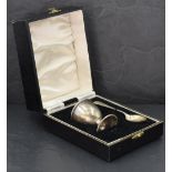 A cased silver egg cup and spoon of plain form, Birmingham 1950, W I Broadway & Co, approx 31.3g