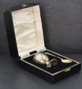 A cased silver egg cup and spoon of plain form, Birmingham 1950, W I Broadway & Co, approx 31.3g