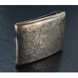 A silver cigarette case having extensive engraved scroll decoration and monogrammed cartouche,