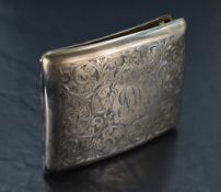 A silver cigarette case having extensive engraved scroll decoration and monogrammed cartouche,
