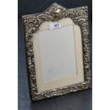 An Edwardian silver photograph frame having extensive cut decoration, plain cartouche and purple