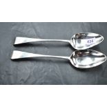 A pair of George III silver Old English pattern table spoons, each with Hanovarian reverse and