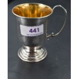 An Elizabeth II silver christening mug, with scrolled loop handle, gilt interior and stepped