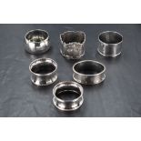 A group of six mixed silver napkin rings, of varying size, shape, age and design, 93grams gross.