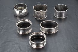 A group of six mixed silver napkin rings, of varying size, shape, age and design, 93grams gross.