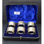 A cased set of six George V silver napkin rings, of circular form with moulded edge detail, engraved