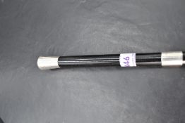 An early 20th Century ebonised conductor's baton having silver terminal, tip & collar, London