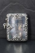 An Edwardian silver vesta case, of hinged rectangular serpentine form and moulded with foliate