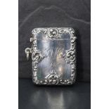 An Edwardian silver vesta case, of hinged rectangular serpentine form and moulded with foliate