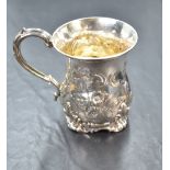 A Victorian Christening tankard having repousse floral decoration, plain cartouche and moulded