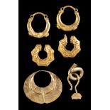 AN ASSORTED GROUP OF SEVEN GOLD EARRINGS, JAVA, INDONESIA, PROBABLY 10TH-14TH CENTURIES