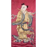 * A CHINESE EMBROIDERED SILK PANEL DEPICTING A FLUTE PLAYER, CIRCA 1900