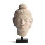 A SMALL GANDHARA STUCCO HEAD OF BUDDHA, NORTH-WESTERN PAKISTAN OR AFGHANISTAN, 4TH / 5TH CENTURY