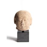 A MAJAPAHIT PUMICE HEAD OF A MONK, JAVA, INDONESIA, CIRCA 14TH CENTURY
