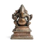 A BRONZE FIGURE OF GANESHA