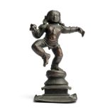 A BRONZE FIGURE OF KRISHNA