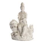A CHINESE DEHUA FIGURE OF GUANYIN SEATED ON A LION