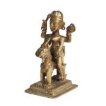 A BRONZE FIGURE OF DURGA RIDING ON HER LION