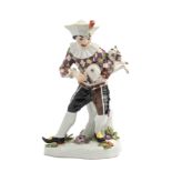 A MEISSEN FIGURE OF HARLEQUIN PLAYING A PUG