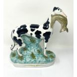 A STAFFORDSHIRE POTTERY FIGURE OF A WHIPPET (OR GREYHOUND)